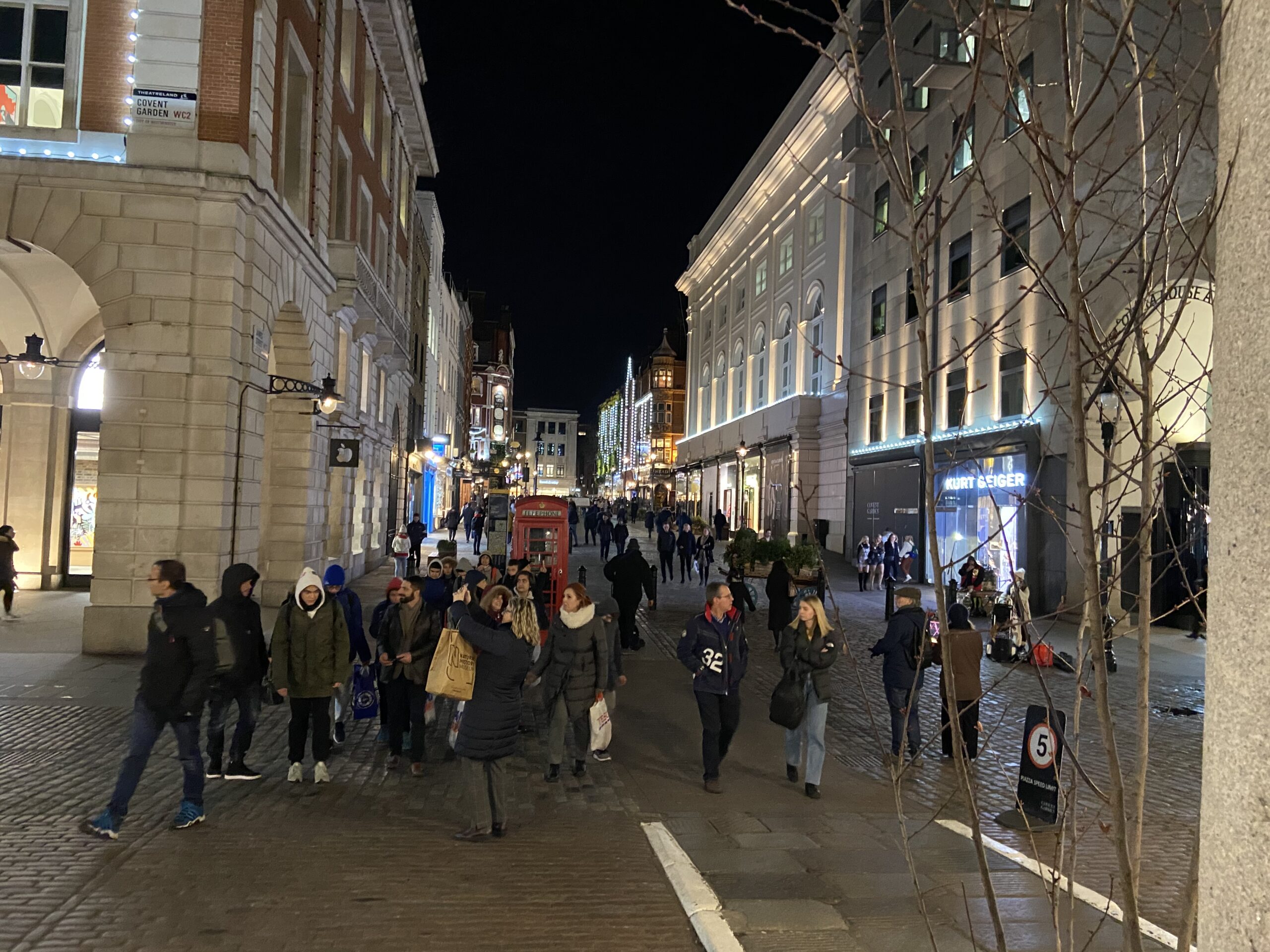 Drukke straat bij Covent Garden 's avonds met menigte